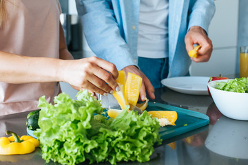 Young couple cooking a vegetarian breakfast in the morning in a bright kitchen
