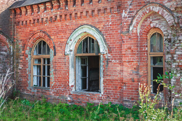 Old, dilapidated house. The property is overgrown with plants.