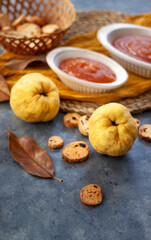 Quince Close up with a jelly quince in a white crockery containers and little toasts to spread.