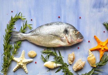 dorado fish on a blue background with herbs, shells and starfish, flat lay with space for text