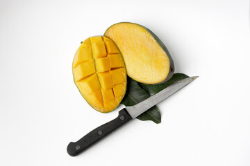 Sliced or chopped mangoes fruit with knives, ripe and fresh