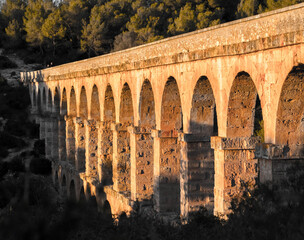 Tarragona Spain. Roman Ponte.Roman aqueduct with arches. Blue sky with sunset. 