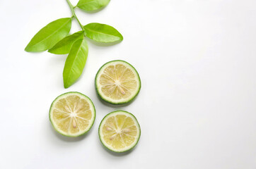 Sliced limes against white background