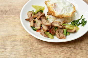 spicy stir fried slice grilled pork with chili and basil leaf topping egg on dish