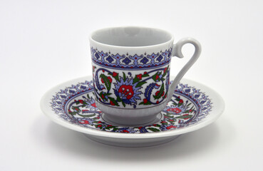 Plate and cup on a white background. Turkish coffee set. Isolated. Side view. Close-up.