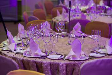 served table with a tablecloth at a restaurant reception in the evening