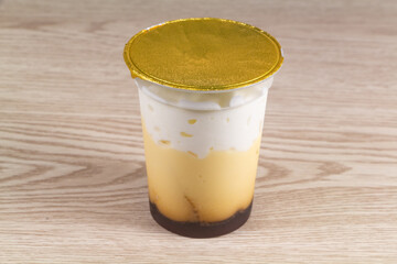 Viennese yogurt in a plastic pot with golden seal