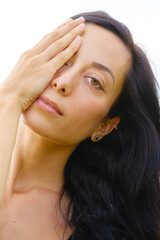 Fototapeta premium Close up portrait of an attractive, woman with long hair and strong features, on white background