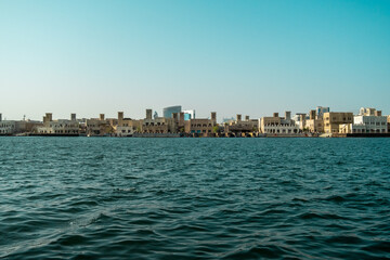 Boat marina on the canal in the middle of the city. View of Dubai Creek from the Deira area. 