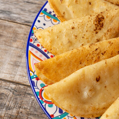 Mexican potato fried tacos on wooden background