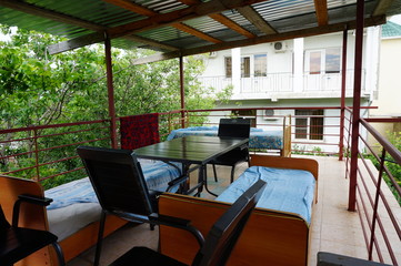 Bed and table on the veranda. House for tourists.