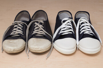 Old dirty shabby and new clean unworn sneakers