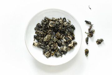 Fototapeta premium Dried green tea leaves on white background