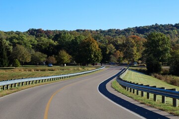 The winding road in the country on a sunny autumn day.