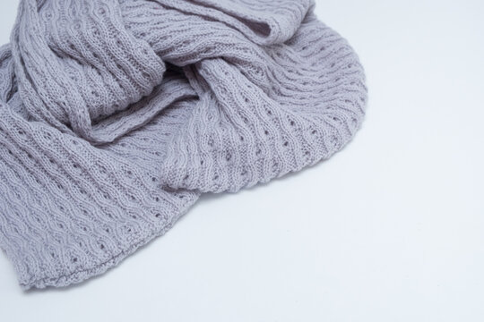 gray knit scarf snud on a white table