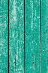 Old and peeling paint Over time, the green paint peeled off from the old boards and the wood texture cracked. Vintage Abstract Grunge Background