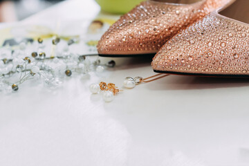 wedding details. Shoes, earrings, pendant and head jewelry near