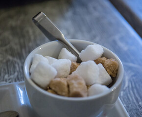 A bowl filled with sugar cubes at a coffee shop