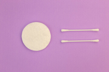 Flat lay composition with cotton hygienic products on pastel violet background