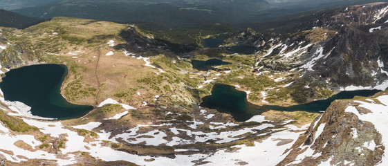 Aerial panoramic view of Seven Rila Lakes covered in snow during early summer day near in Rila Mountain (near Sofia, Bulgaria, Europe)