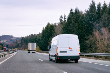 Fototapeta na wymiar White Minivan in road