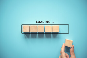 Loading with hand putting wood cube in progress bar.