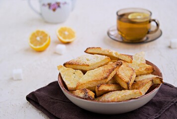 Homemade cottage cheese biscuits in a clay bowl on a light background concrete. Baking with cottage cheese.