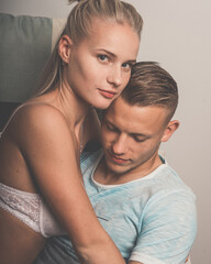 Romantic couple at home. Attractive young woman and handsome man are enjoying spending time together.