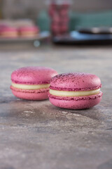 two macarons on a gray table. Flash photo. Space for text. Background