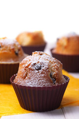 Handmade vanilla muffins on a wooden table