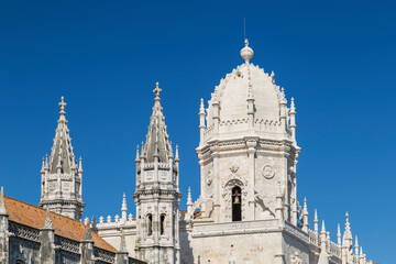 Fototapeta na wymiar Close-up of towers of the historic Mosteiro dos Jeronimos (Jeronimos Monastery) in Belem, Lisbon, Portugal, on a sunny day.