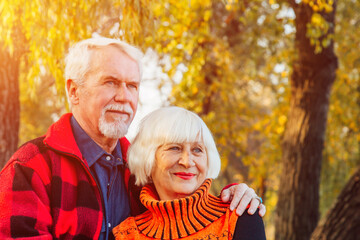Happy senior couple enjoying each other in the park. Support and care from a loved one, warm emotions.