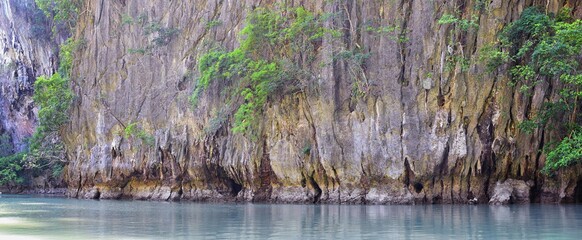 Island, Ocean views near Phuket Thailand with Blues, Turquoise and Greens oceans, mountains, boats, caves, trees resort island of phuket Thailand. Including Phi Phi, Ko Rang Yai, Ko Li Pe and other is