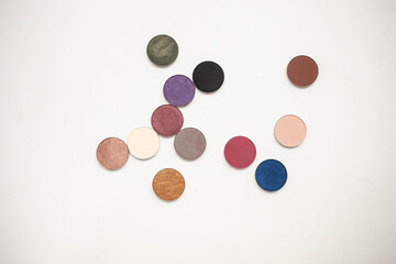 beauty concept. twelve different shades of shadow in round shapes on a white background