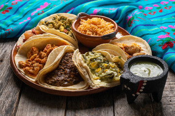 Mexican stew tacos also called "guisados" with rice on wooden background