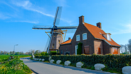 Traditional dutch windmill near the canal. Netherlands