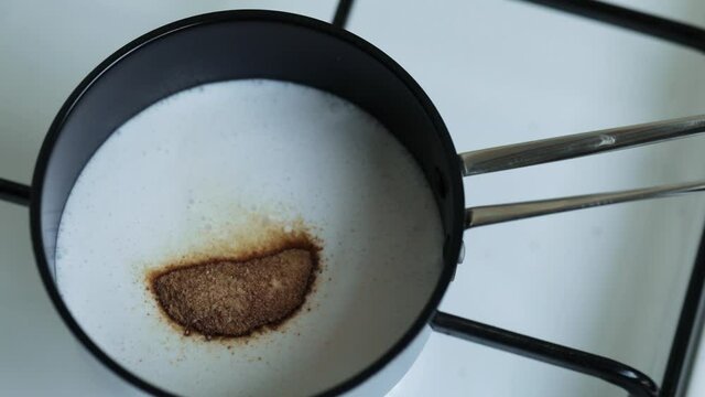 Milk pot and shugar spoon on cooker