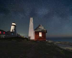 Lighthouse and Oil House at night with stars and milky way