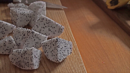 Pieces of pitaya dragon fruit on cutting board