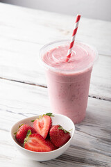 strawberry smoothie in disposal plastic cup