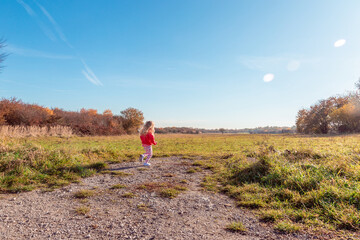 Little girl running into the meadow