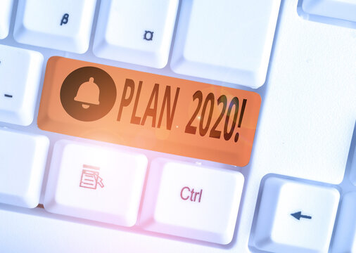 Text sign showing Plan 2020. Business photo text detailed proposal doing achieving something next year White pc keyboard with empty note paper above white background key copy space