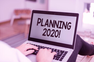 Text sign showing Planning 2020. Business photo text process of making plans for something next year woman laptop computer office supplies technological devices inside home