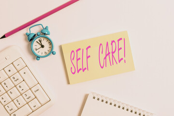 Text sign showing Self Care. Business photo text practice of taking action to preserve or improve ones own health White pc keyboard with empty note paper and pencil above white background