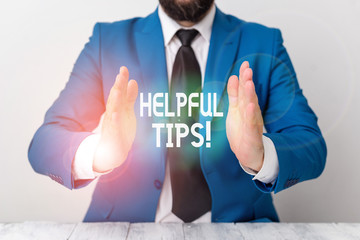 Word writing text Helpful Tips. Business photo showcasing advices given to be helpful knowledge in life Man holds empty paper with copy space in front of him Space