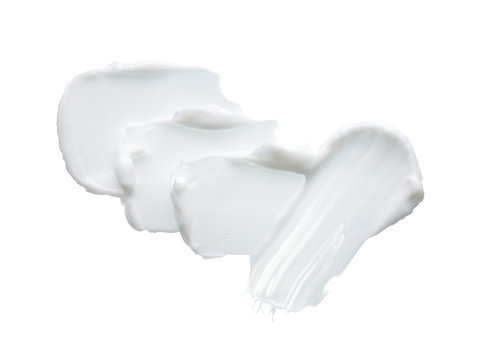 White texture and smear of face cream or white acrylic paint isolated on white background