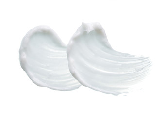 Fototapeta na wymiar White texture and smear of face cream or white acrylic paint isolated on white background