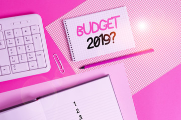 Writing note showing Budget 2019 Question. Business concept for estimate of income and expenditure for next year Writing equipments and computer stuffs placed above colored plain table