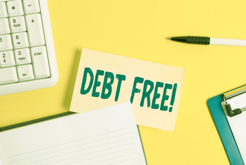 Word writing text Debt Free. Business photo showcasing does not owning any money to any individual or companies Empty orange paper with copy space on the yellow table