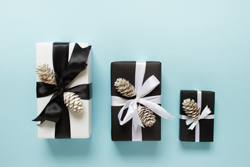 Three gift boxes with pine cones  on blue backgound